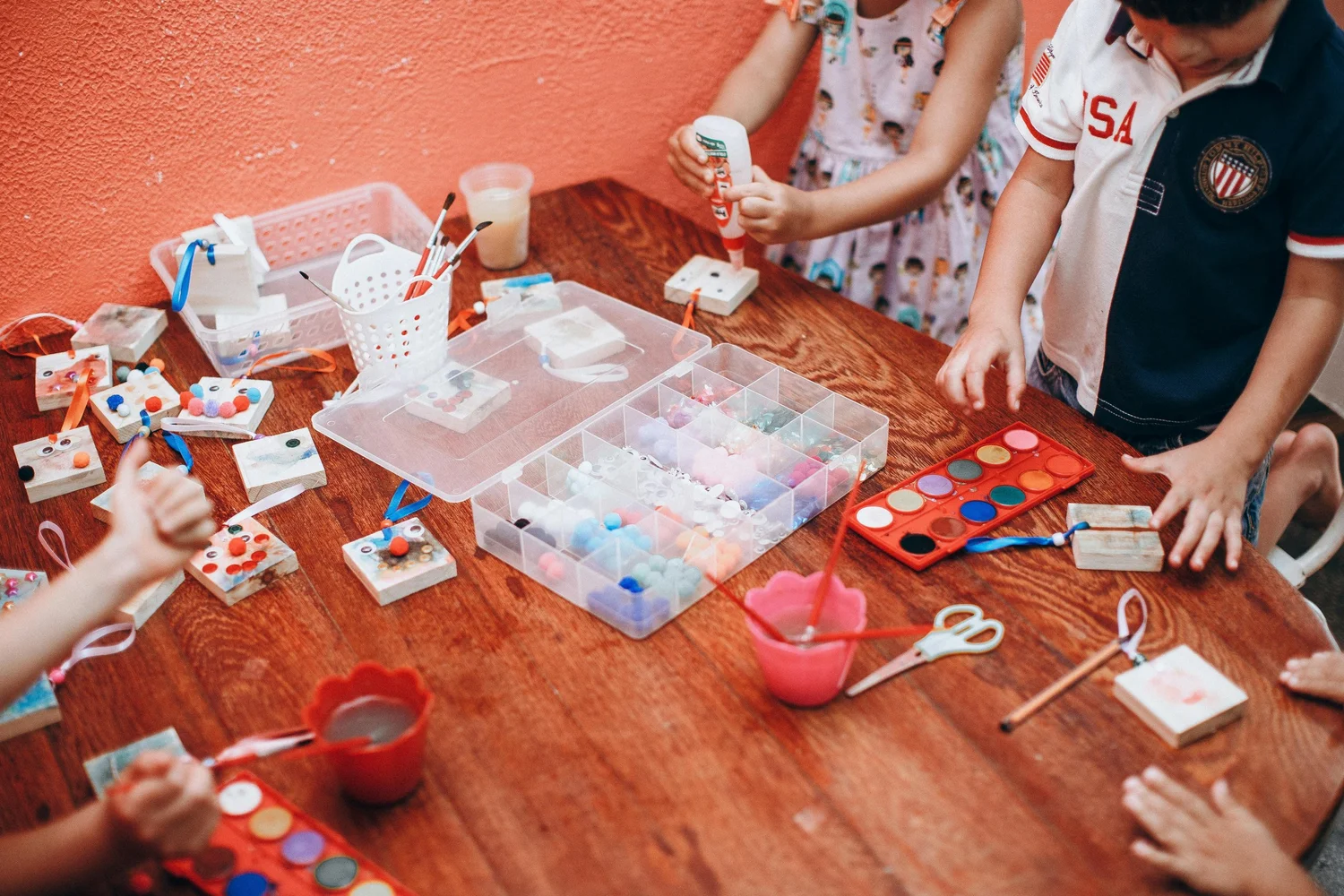 Children creating art together around a classroom table