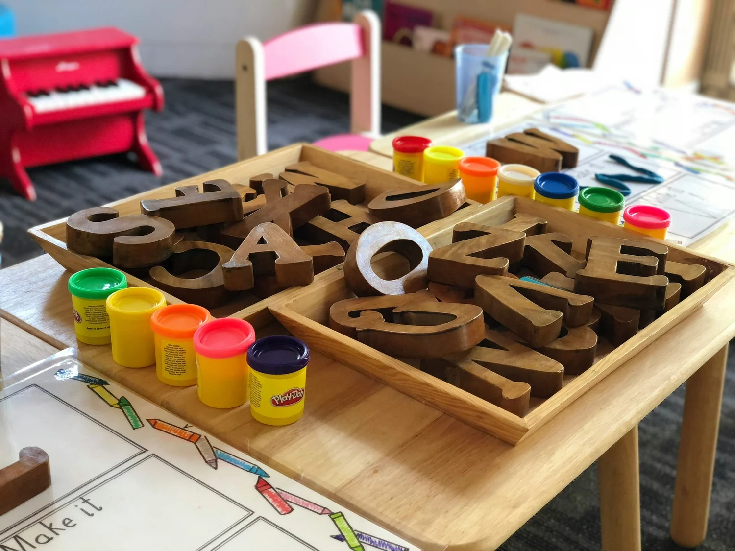 Preschool art and learning materials arranged on a classroom table