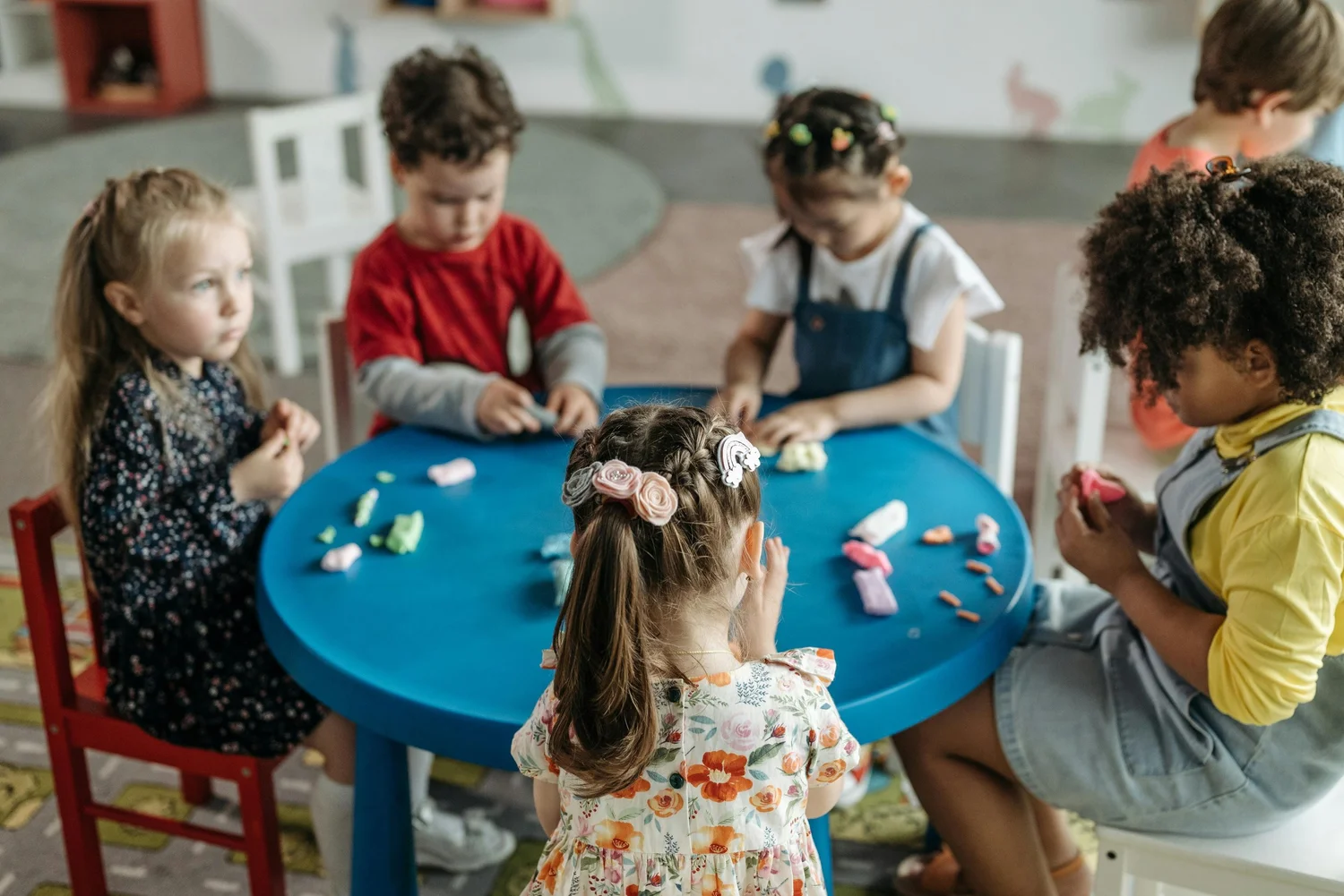 Children gathered around a classroom activity table
