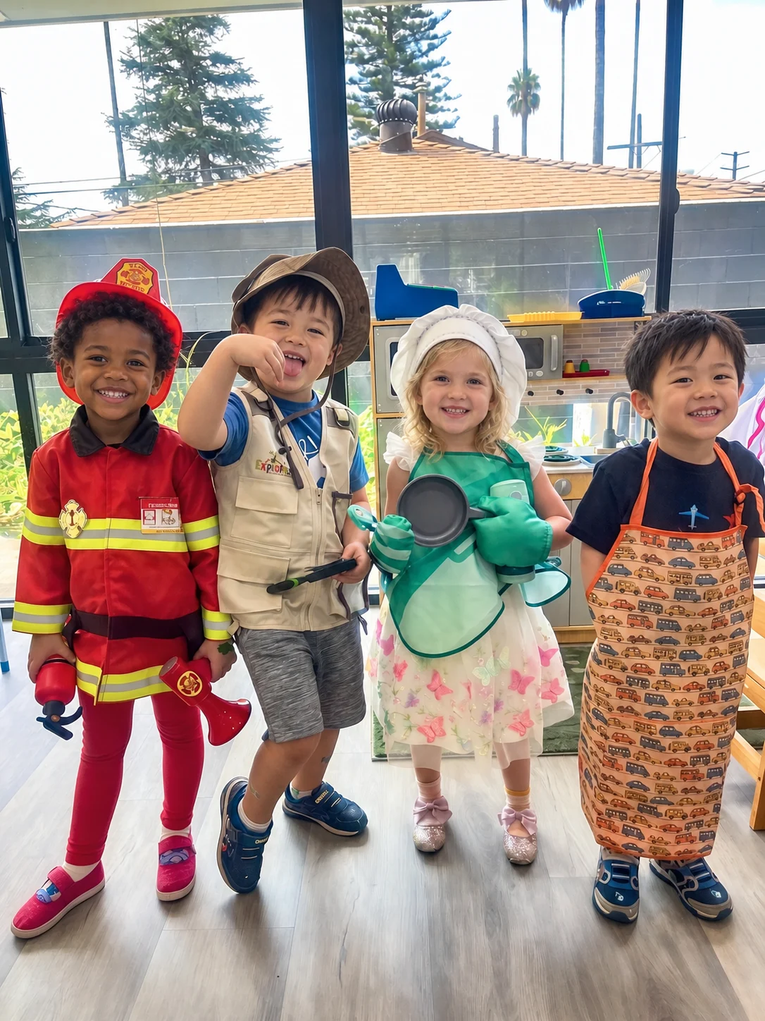 Illustrative image of four preschool children enjoying dress-up play as a firefighter, explorer, chef, and helper